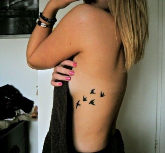 tatuagem pássaros costela