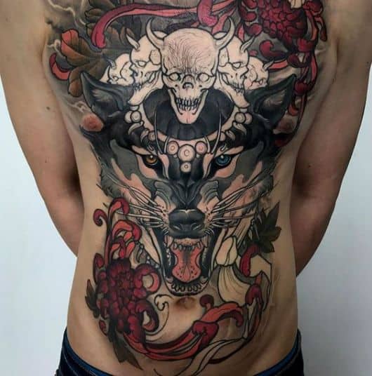Tatuagem em estilo oriental de um lobo que preenche a barriga e o peito de um homem