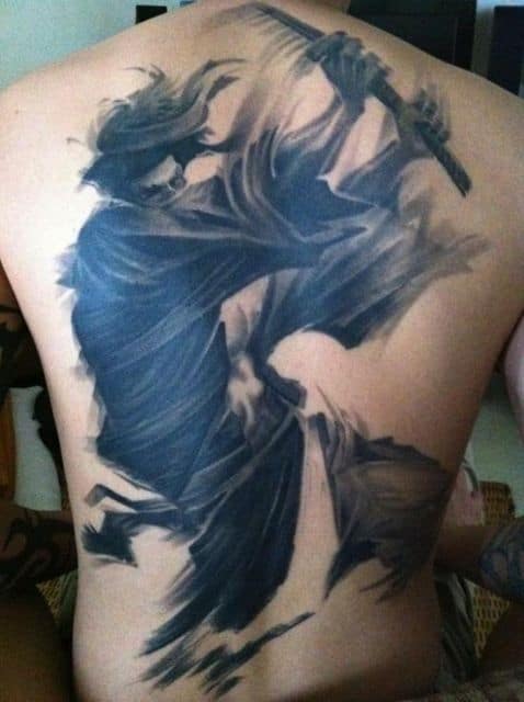 Tatuagem grande de samurai nas costas. Ela é feita para passar a impressão de uma sombra de samurai atacando com sua espada. 