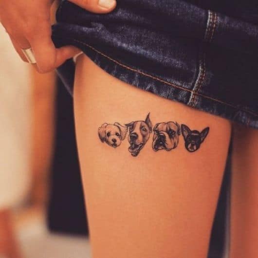 Tatuagem de quatro cachorros.