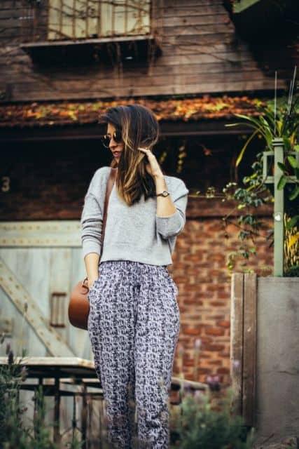 Blogueira usando calça indiana e blusa cinza.