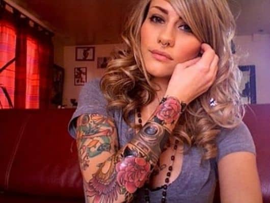 tatuagem braço fechado feminino com desenhos florais