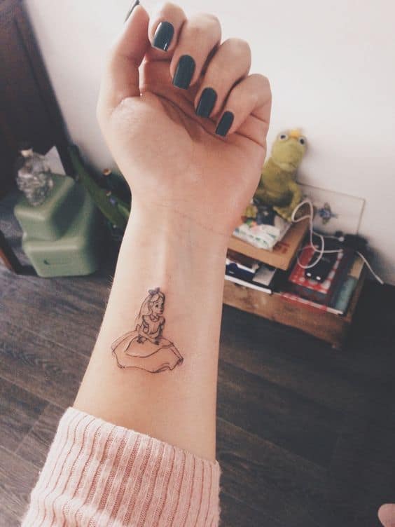 tattoo pequena e delicada no pulso de Alice no País das Maravilhas