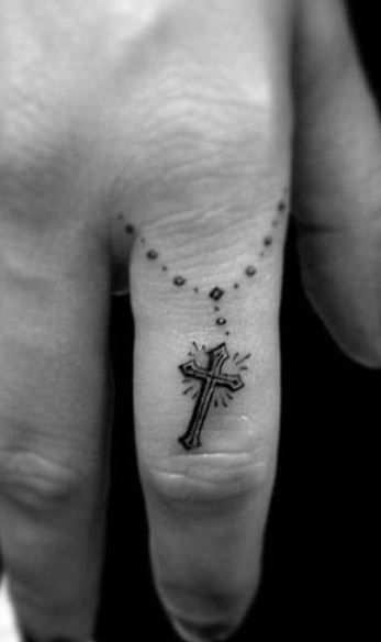 cruz linda tatuada no dedo